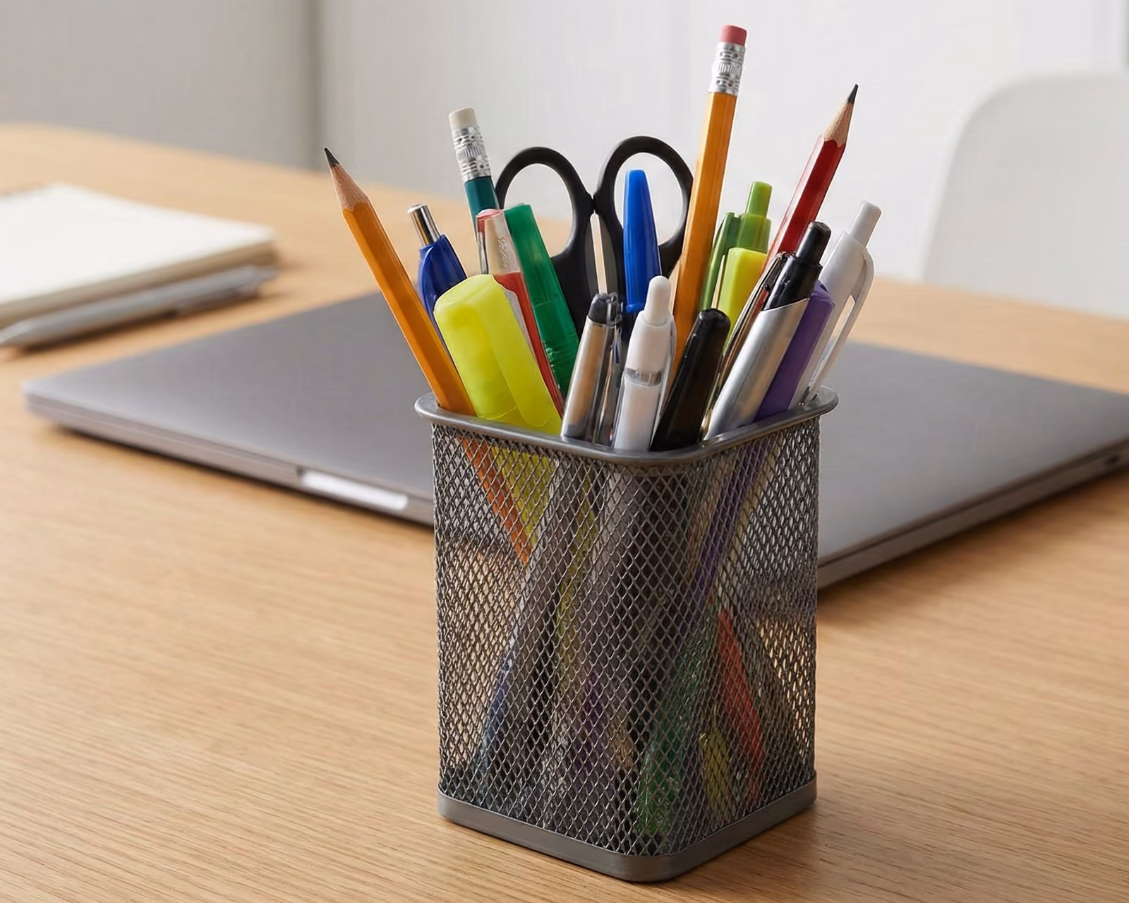 A mesh pen holder, where dust collects
